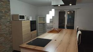a kitchen with a wooden counter top in a room at chez anita in Magny-en-Vexin