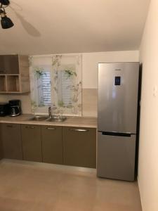 a kitchen with a refrigerator and a sink at Albatros in Kastel Sucurac