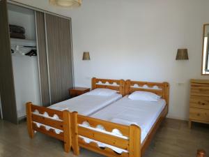 Schlafzimmer mit einem Holzbett mit weißer Bettwäsche in der Unterkunft Milto's Studios in Parga