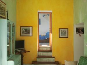 Habitación con pared amarilla y escalera en B&B Borgo Marinaro, en Pozzuoli