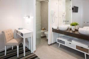 a bathroom with two sinks and a desk and a toilet at Marino Lisboa Boutique Guest House in Lisbon