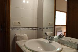 a bathroom with a sink and a mirror at Casa Teresina in La Plana de Mont-Ros