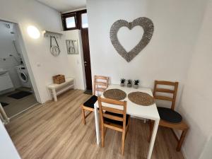 a dining room with a table and a heart on the wall at KnocksCasa4you 2 Zimmer Monteure Appartement Nr 21 in Marburg in Marburg an der Lahn