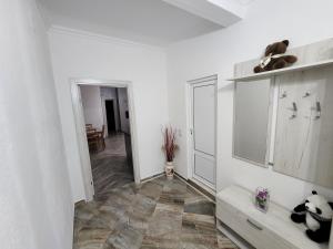 a white room with a hallway with a tiled floor at Apartments Cota Guesthouse in Ulcinj +106 photos