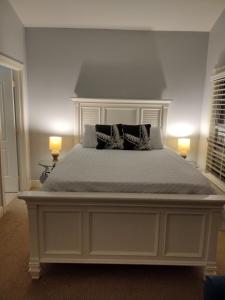 a large white bed with two pillows on it at Anglers Reef Getaway in Islamorada