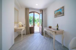 a bathroom with a table and a sink and a door at Minissale Farmhouse in Calatabiano