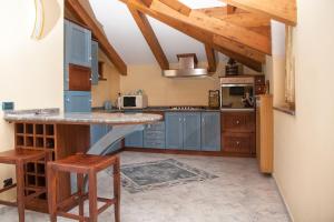 a kitchen with blue cabinets and a counter top at The Sweet Garret in Agerola