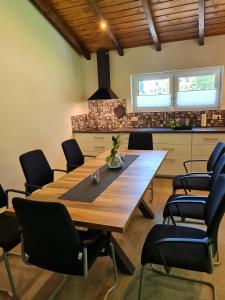 a dining room with a wooden table and chairs at Haus DeMa in Walkenried