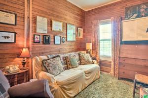 a living room with a couch and wooden walls at Historic Sparta Home Near Waterfalls and Hikes! in Sparta