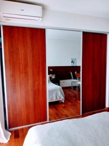 a bedroom with a bed and a large mirror at Estudio Paraná in Rosario