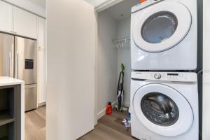a washer and dryer in a laundry room with at Kensington Suite 2bed & 1bath in Calgary