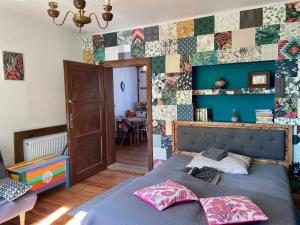 a bedroom with a bed and a wall of tiles at Apartament Do Zobaczenia Olsztyn in Olsztyn