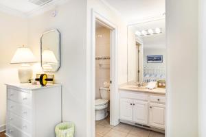 a bathroom with a toilet and a sink and a mirror at Rehoboth Beach --- 6 Holly Road in Rehoboth Beach +49 photos