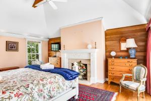 a bedroom with a bed and a fireplace at Rehoboth Beach --- 6 Holly Road in Rehoboth Beach