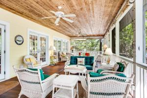 a porch with chairs and a ceiling fan at Rehoboth Beach --- 6 Holly Road in Rehoboth Beach