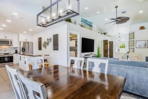 a kitchen and living room with a wooden table and chairs at Sun-Drenched Sojourn in Marco Island