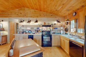 a large kitchen with wooden walls and wooden floors at Retreat at Long Point in Orland