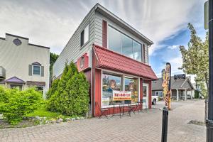 a building with a red roof and a restaurant at Walkable St Ignace Condo with Lake Huron Views in Saint Ignace