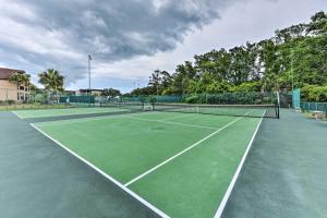 a tennis court with two tennis rackets on it at Hilton Head Resort Getaway - Walk to Beach! in Hilton Head Island
