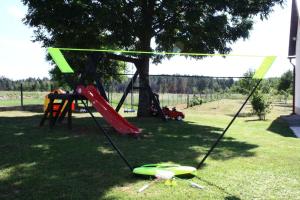 a playground with a slide and a swing set at Kuća za odmor Antonio in Gospić