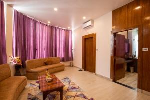 - un salon avec un canapé et une table dans l'établissement Nansc Hotel, à Siddharthanagar