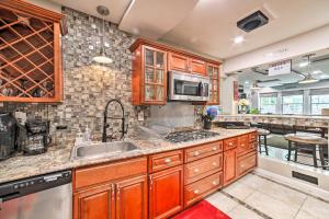 a kitchen with wooden cabinets and a sink at Pittsburgh Home with Pool, Fire Pit and Game Room in Pittsburgh