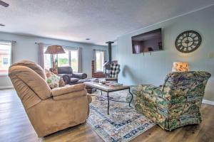 a living room with a couch and a chair and a table at Charming Choteau Apartment Central Location! in Choteau