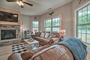 a living room with a couch and a fireplace at Stunning Helen Getaway with Private Hot Tub! in Helen