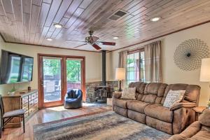 a living room with a couch and a tv at Retreat with Lake Access and Private Boat Dock! in Bemidji