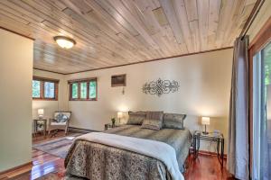 a bedroom with a bed and a wooden ceiling at Retreat with Lake Access and Private Boat Dock! in Bemidji