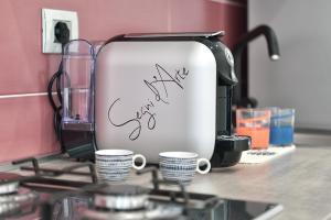 a coffee maker sitting on top of a counter with cups at Serenis Luxury Apartments in Minori