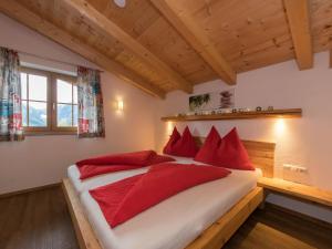 a bedroom with a large bed with red pillows at Apartment in Kaprun near the ski area in Kaprun