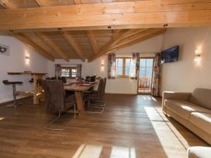 a living room with a table and a couch at Apartment in Kaprun near the ski area in Kaprun +32 photos