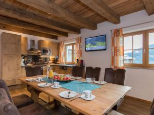 a kitchen and dining room with a wooden table at Apartment in Kaprun near the ski area in Kaprun