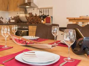 a table with white plates and wine glasses on it at Apartment in Kaprun near the ski area in Kaprun +31 photos