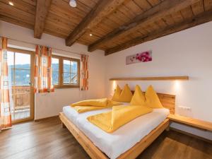 a bedroom with a large bed with yellow pillows at Apartment in Kaprun near the ski area in Kaprun