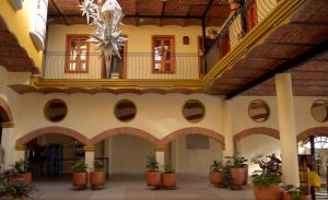 a large building with a ceiling with a chandelier at OYO Hotel Castillo Santa Cecilia in Tapalpa