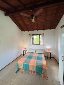 a bedroom with a bed in a room with a ceiling at Buzios Casa n# 2 in Búzios