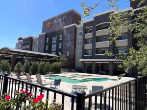 a hotel with a swimming pool in front of a building at La Quinta Inn & Suites by Wyndham Lubbock Southwest in Lubbock