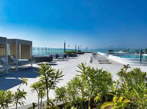 a patio with chairs and a pool on a building at Maritima in Nuevo Vallarta 