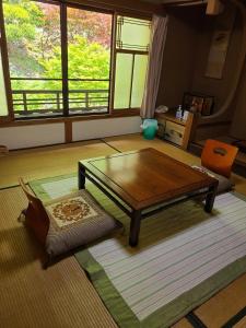- un salon avec une table basse sur un tapis dans l'établissement Ichimaru Ryokan - Vacation STAY 59257v, à Tenkawa