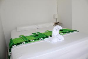 En eller flere senge i et værelse på CASA VERDE Habitaciones en Bucaramanga