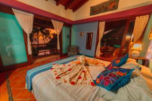 a bedroom with a bed in a room at Tres Mujeres Hotel in Troncones