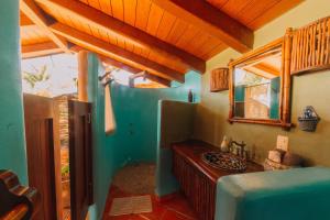 a bathroom with a sink and a mirror at Tres Mujeres Hotel in Troncones