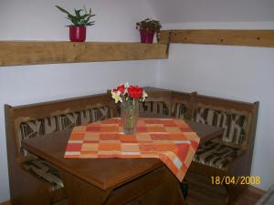 a table with a vase of flowers on it at Casa Sara in Săcele