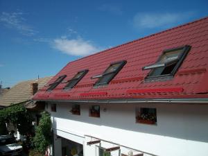 a red roof on top of a building at Casa Sara in Săcele