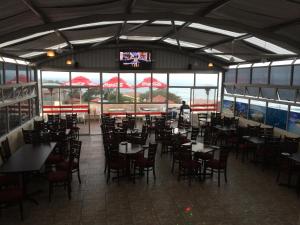 a dining room with tables and chairs in a restaurant at The Norwegian Lodge in Umkomaas