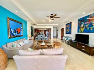 a living room with a couch and a table at Perfect Beach Condo Cap Cana Marina, Punta Cana in Punta Cana
