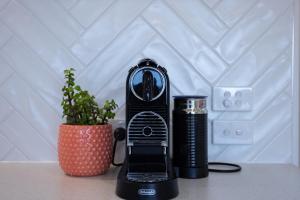 a black blender sitting next to a potted plant at Lakeview Retreat Metung in Metung