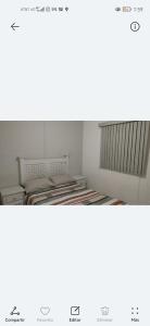 two empty beds in a room with avertisement for at Hermoso departamento Casa Lirio (Real Solare) in Querétaro